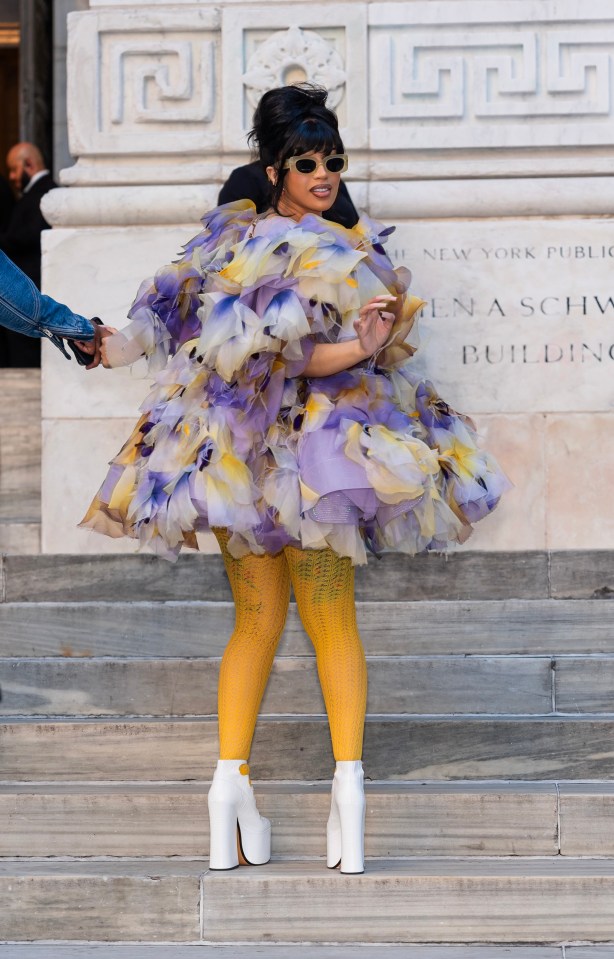 Cardi B also attended wearing this floaty floral dress paired with mustard yellow tights