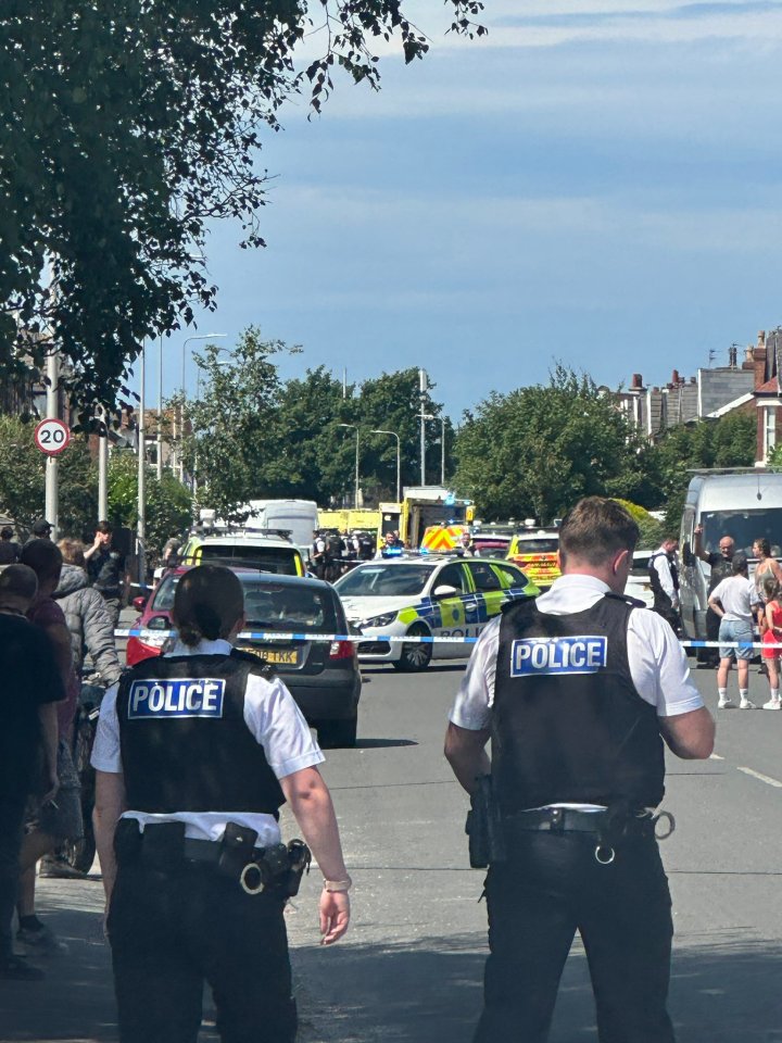 two police officers standing in front of a busy street