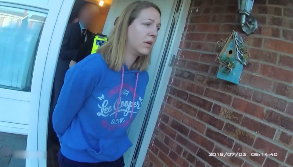 a woman wearing a blue lee cooper sweatshirt stands in front of a door