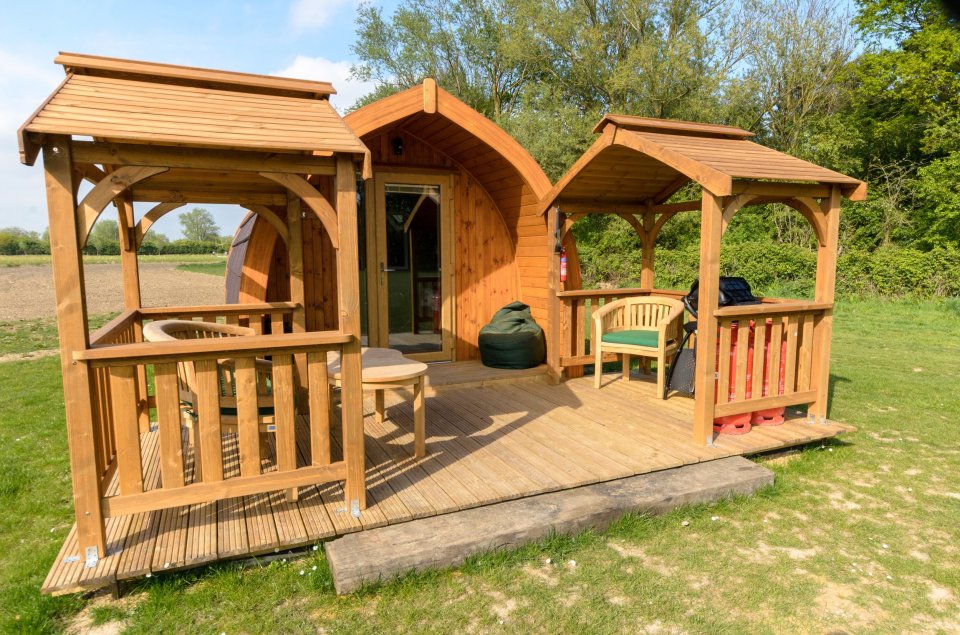 The Woodpecker Pod at Chigborough Farm with a snug double bed, cosy lounge area, compact kitchen and outdoor BBQ space