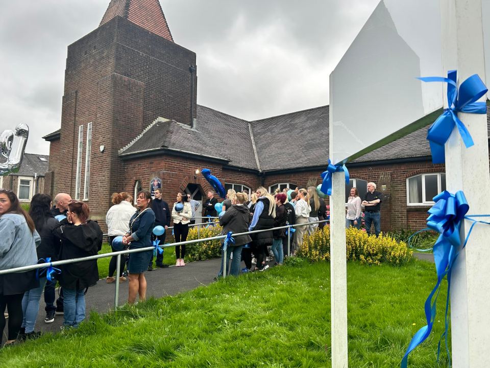 a group of people are gathered outside of a church