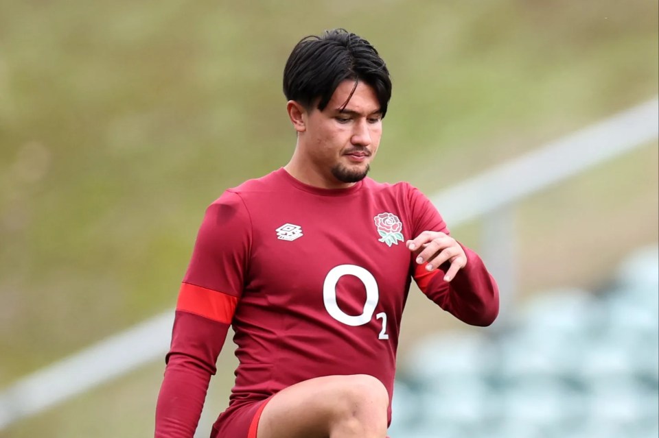 a man wearing a red jersey with the number 02 on it