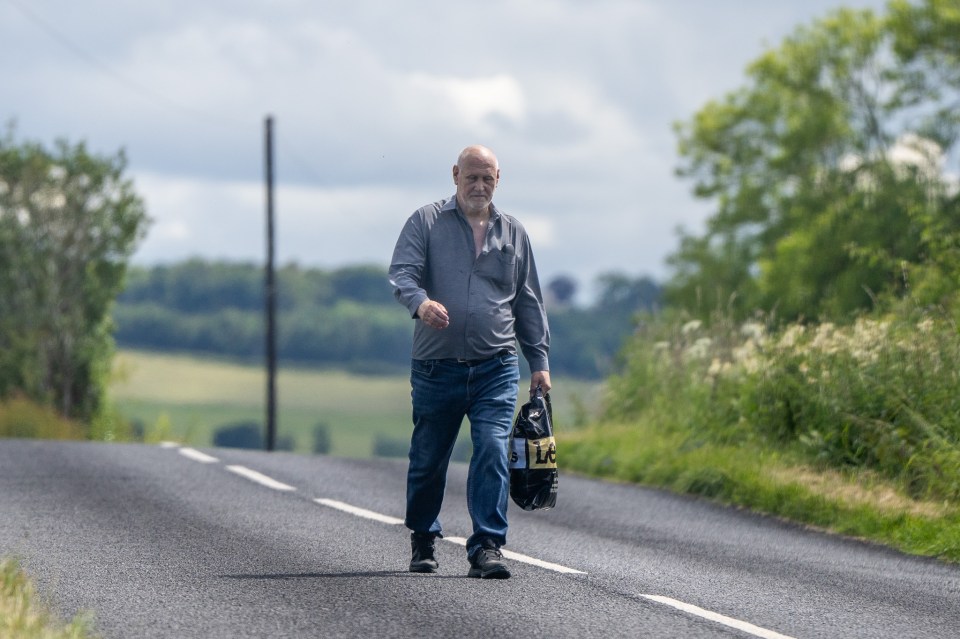 He was walking in the middle of the road clutching a carrier bag