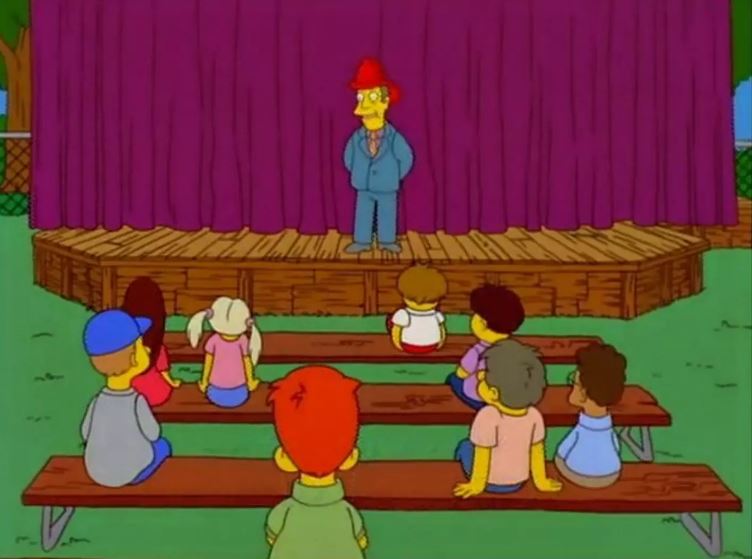 a group of cartoon characters are sitting on benches watching a man on a stage