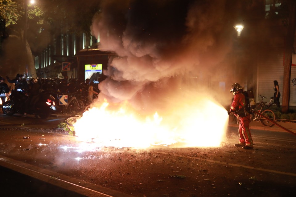 Demonstrators clash with police forces on the outskirts of a gathering for the election night following the second round results