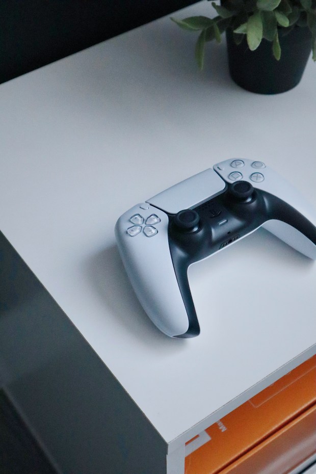 a video game controller is sitting on a white table