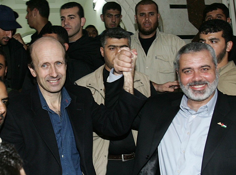 Ismail Haniyeh (R) and BBC correspondent Alan Johnston clasp hands after Johnston was released by Hamas fighters, July 2007 in Gaza