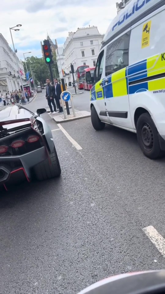 This is the moment a Lamborghini Sian supercar pulls up at set of traffic lights alongside a Met Police van