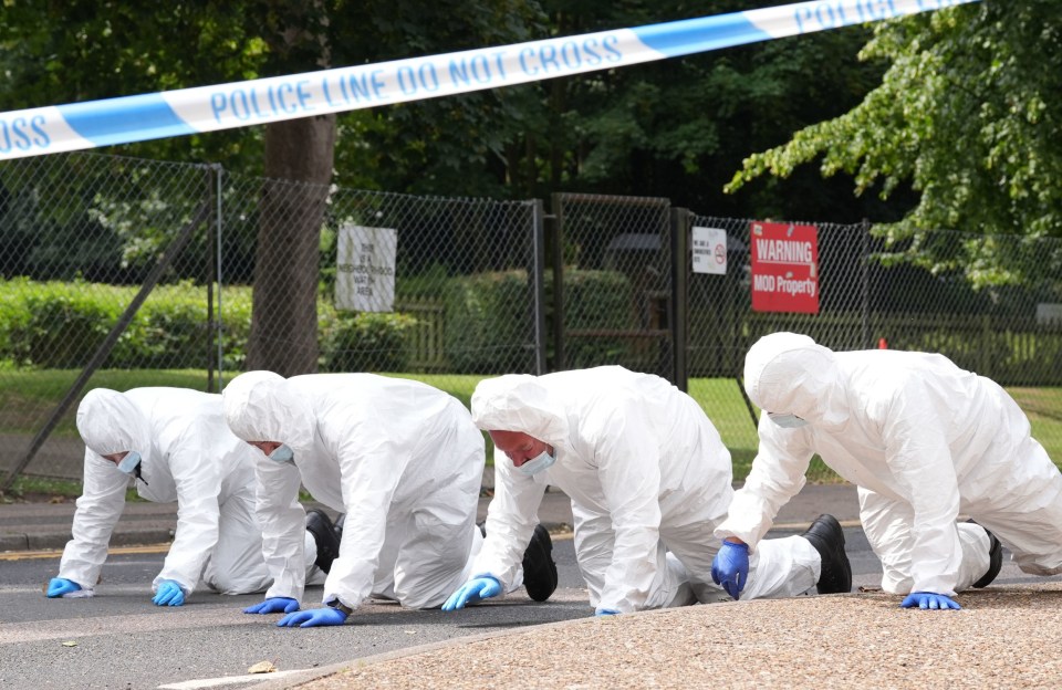 Forensic officers search near the scene at Sally Port in Gillingham, Kent