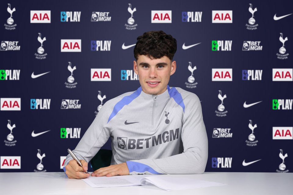 a man signing a contract in front of a backdrop that says aia