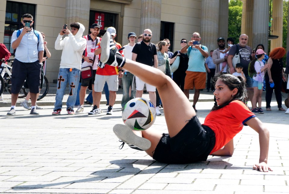 A England fan showing off her skills with a football next to the Brandenburg Gate in Berlin, Germany, ahead of the UEFA Euro 2024 final