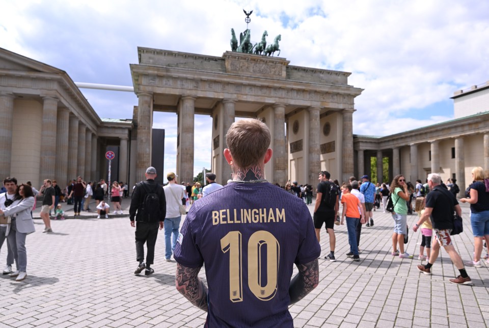 England football fan Jordan, pictured in a Jude Bellingham replica shirt, poses for a picture at the Brandenburg Gate ahead of the Euro 2024 final