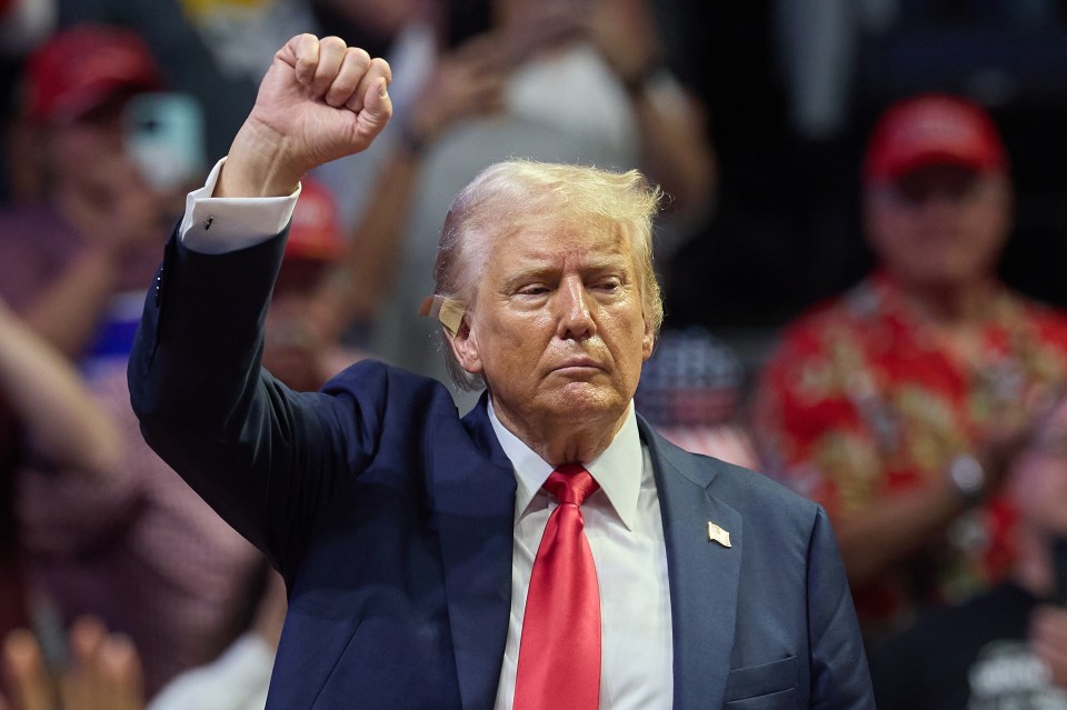 Donald Trump holds his fist up after speaking at his first joint rally with vice presidential nominee Senator JD Vance in Michigan