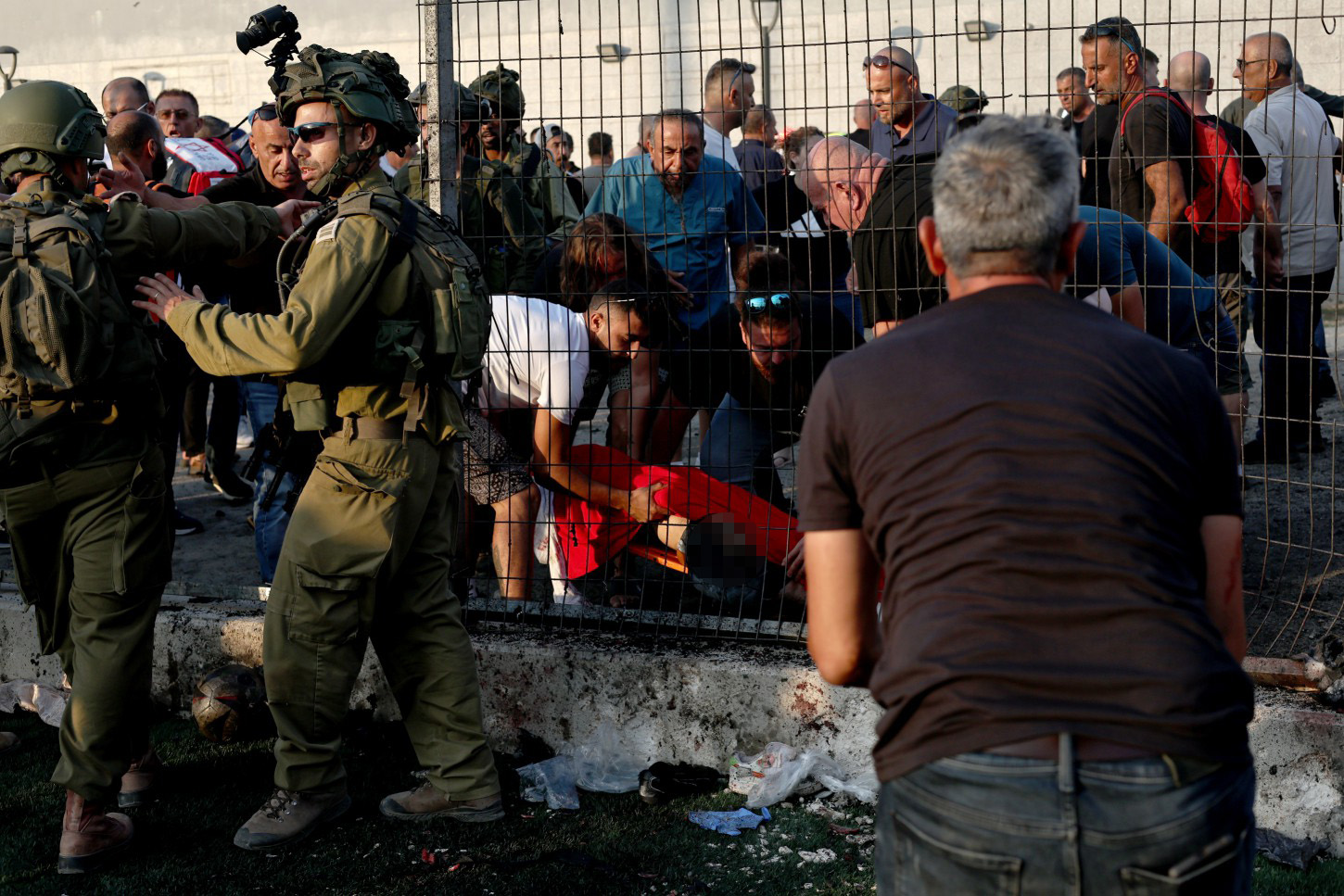 IDF soldiers and medics on the ground at the football field