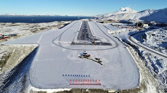 an aerial view of an airport runway covered in snow .