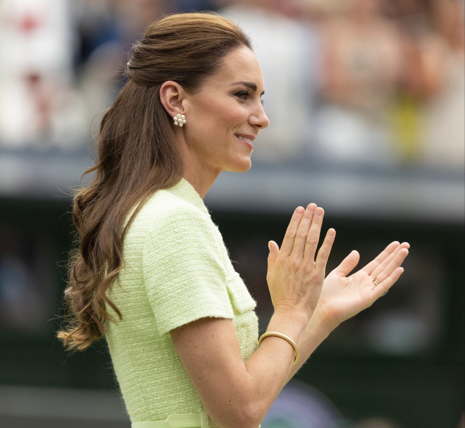 a woman in a yellow dress is clapping her hands