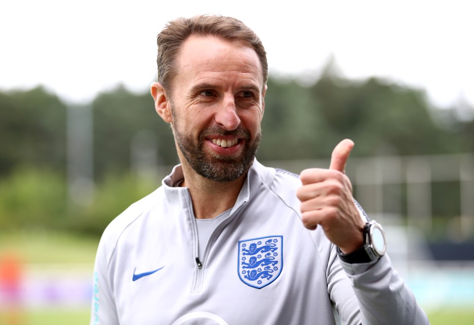 a man giving a thumbs up wearing a nike shirt