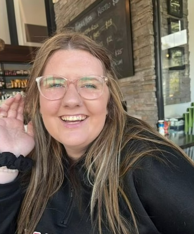 A recent picture showing a happy Shylah with a huge smile on her face while sitting at a cafe