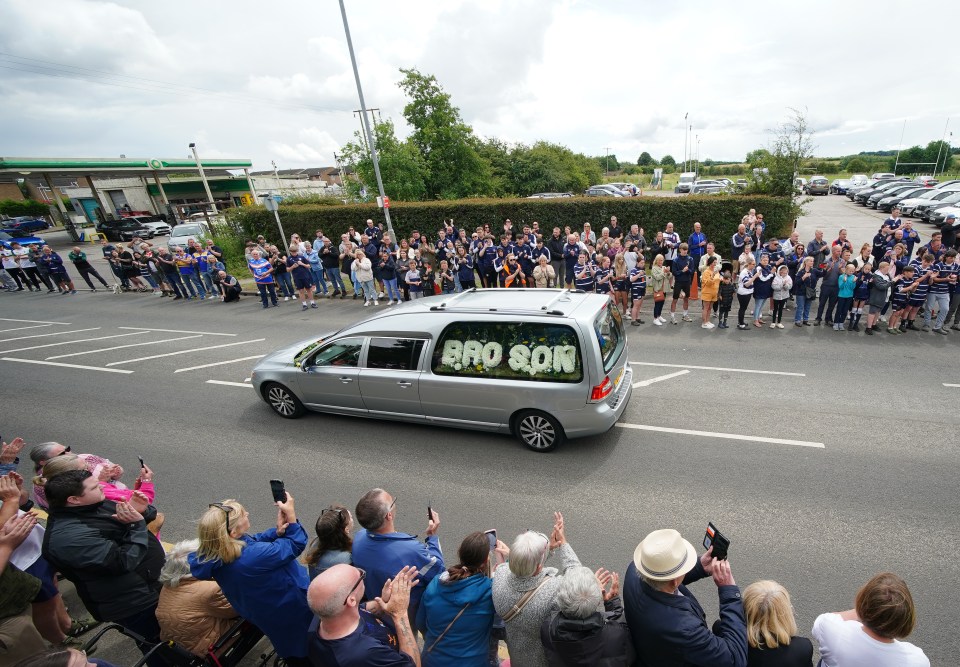 The funeral cortege passes through Featherstone town centre on July 7