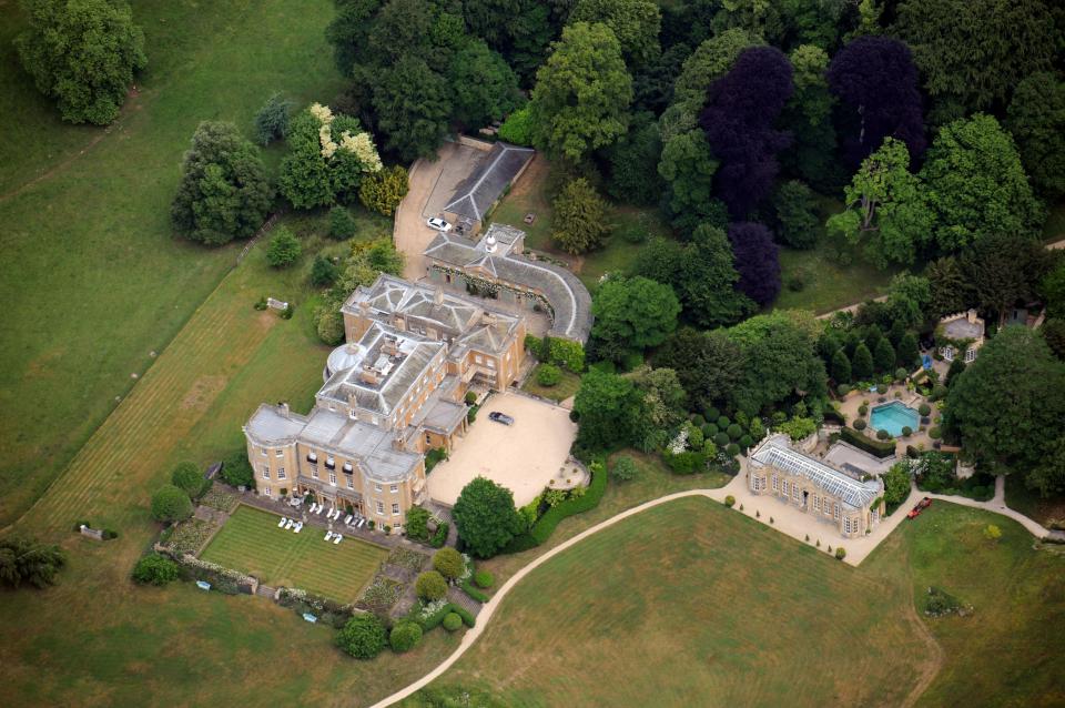 an aerial view of a large house surrounded by trees