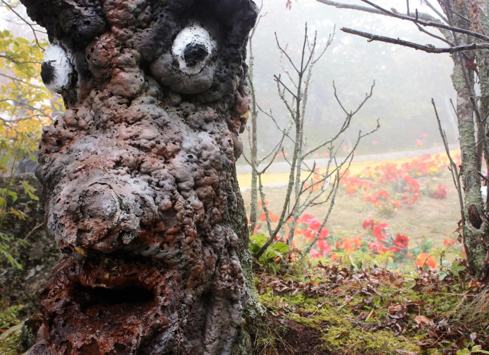 Some fake trees have faces bizarrely attached to them