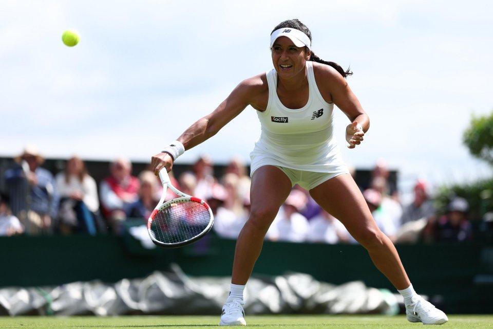 a woman wearing a new balance tank top is playing tennis