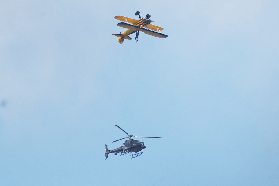 Tom dangled from the wing of a yellow Stearman biplane as cameras rolled in Oxfordshire