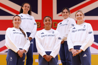 a group of women wearing great britain sweatshirts pose for a picture