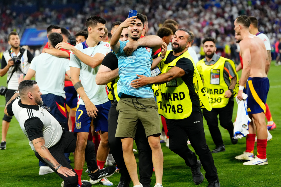 A security member slipped into Alvaro Morata when trying to stop a pitch invader