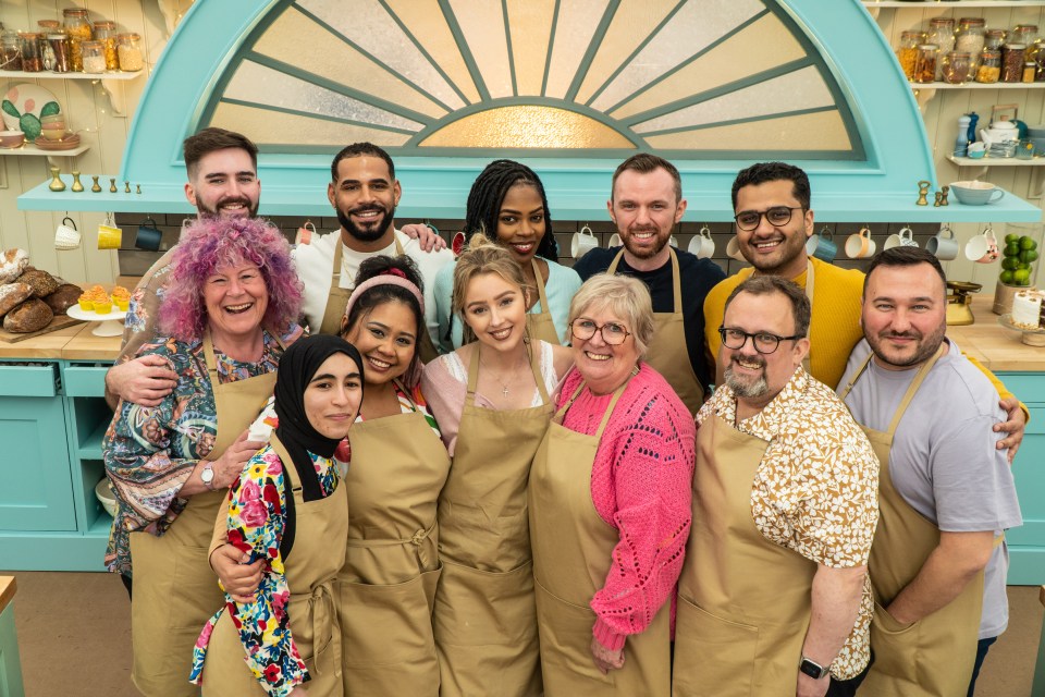 a group of people wearing aprons pose for a picture