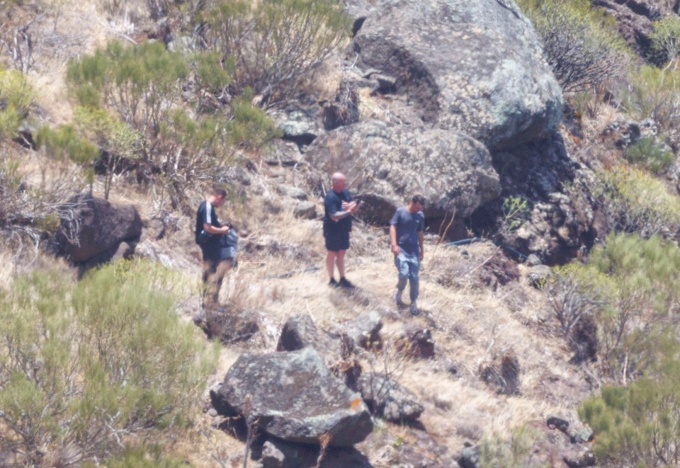 a group of people standing on top of a rocky hillside