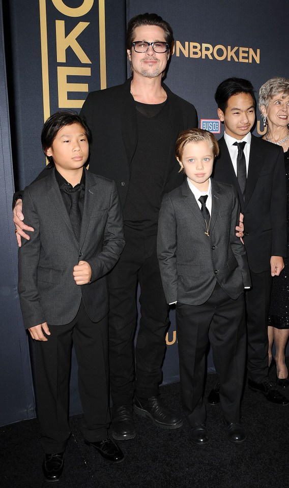 He is pictured with his father Brad Pitt and siblings