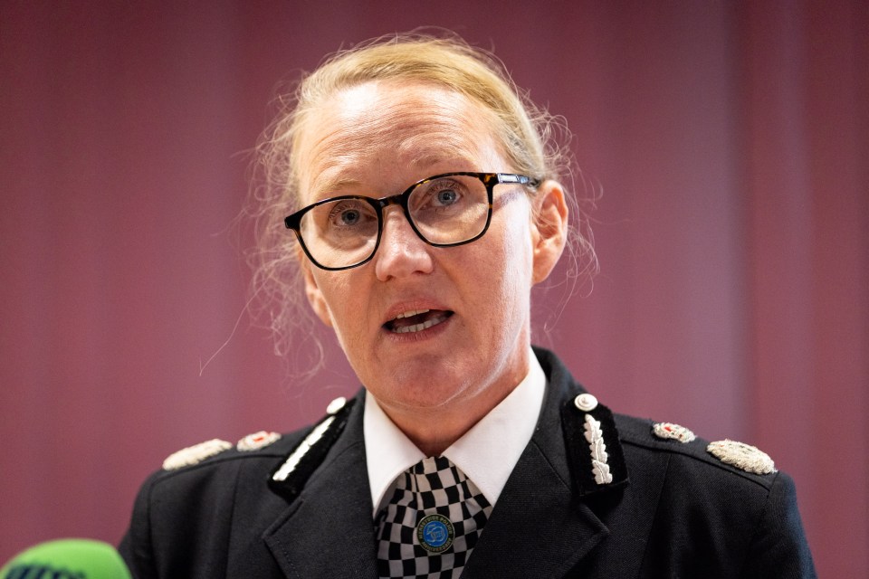 a woman wearing glasses and a badge that says police