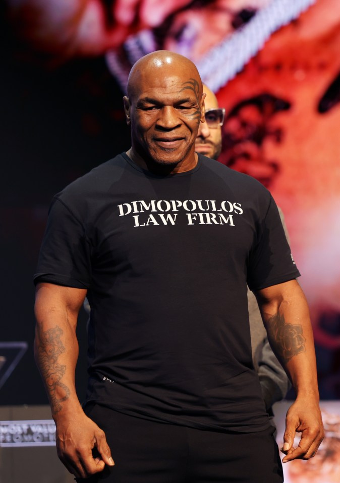 a man wearing a shirt that says ' dimopoulos law firm ' on it