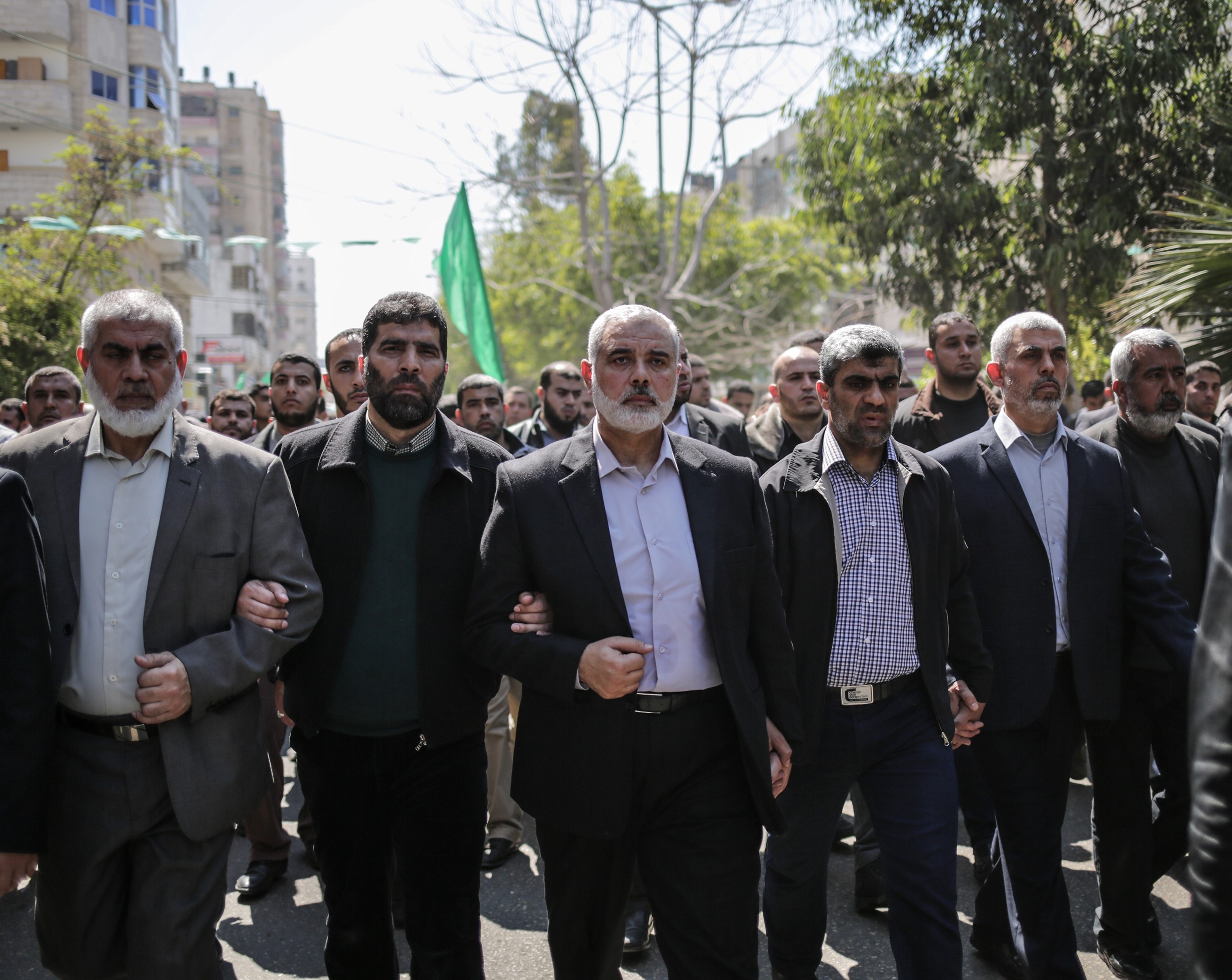 Yahya Sinwar (R) and Ismail Haniyeh (C) with other high-level officers