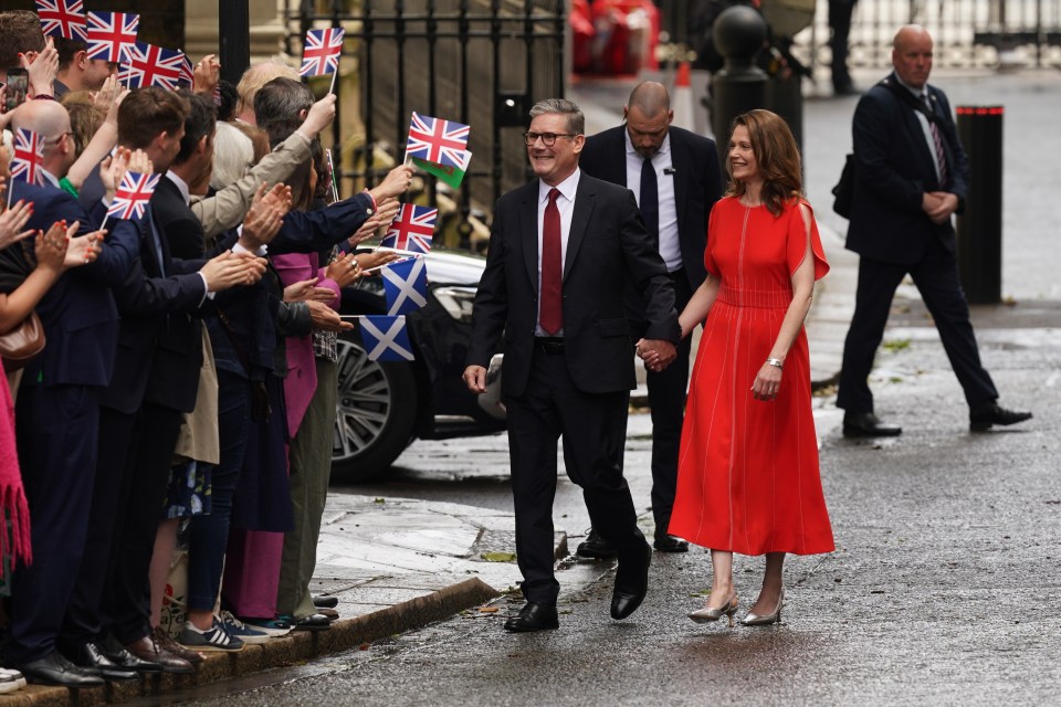 The new PM and his wife on their victory walk to Downing Street