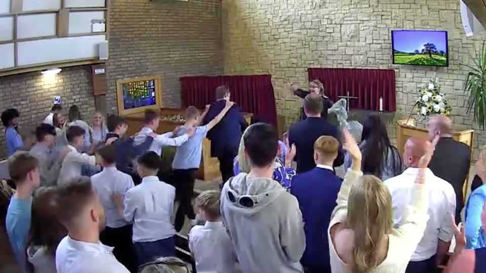 Jake's friends doing the conga at his funeral