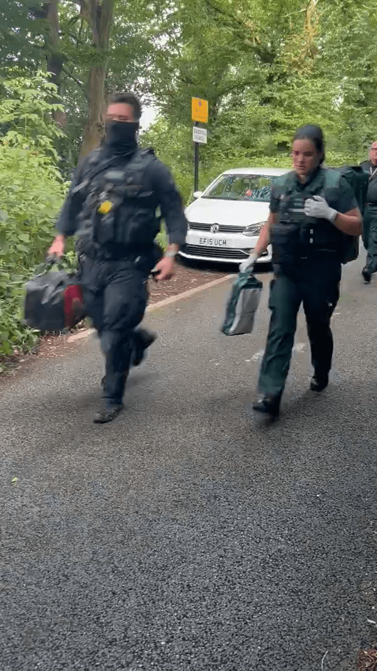 a group of police officers are running down a road