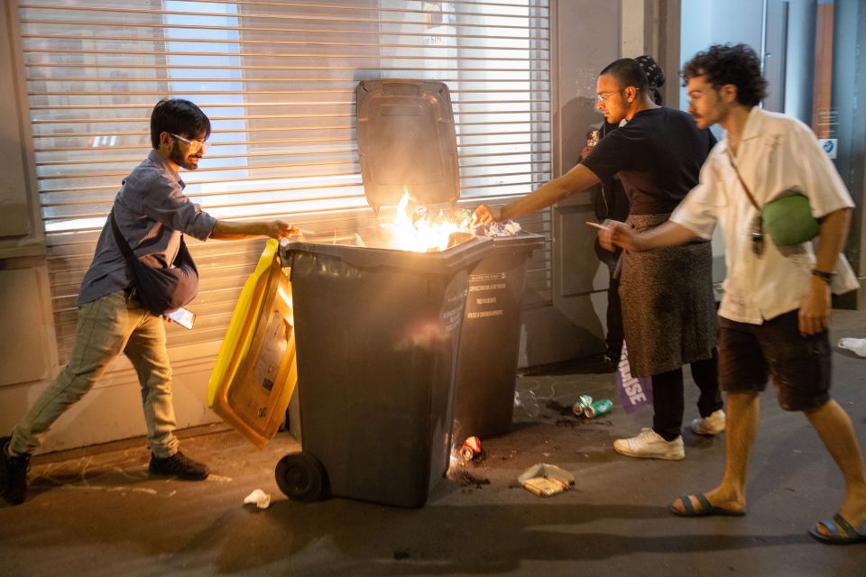 Protestors setting bins on fire