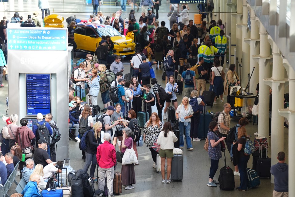 Passengers queue at the Eurostar terminal at St Pancras with trains delayed and cancelled for hours