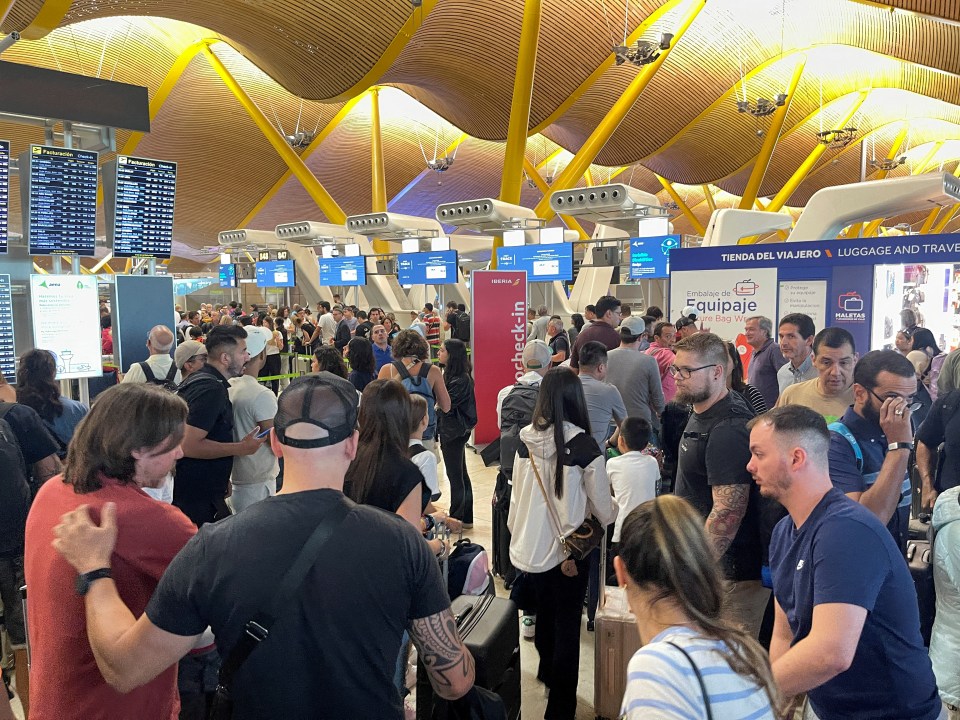 Passengers wait at Barajas Airport in Spain amid severe delays for thousands of Brits heading abroad for the school holidays