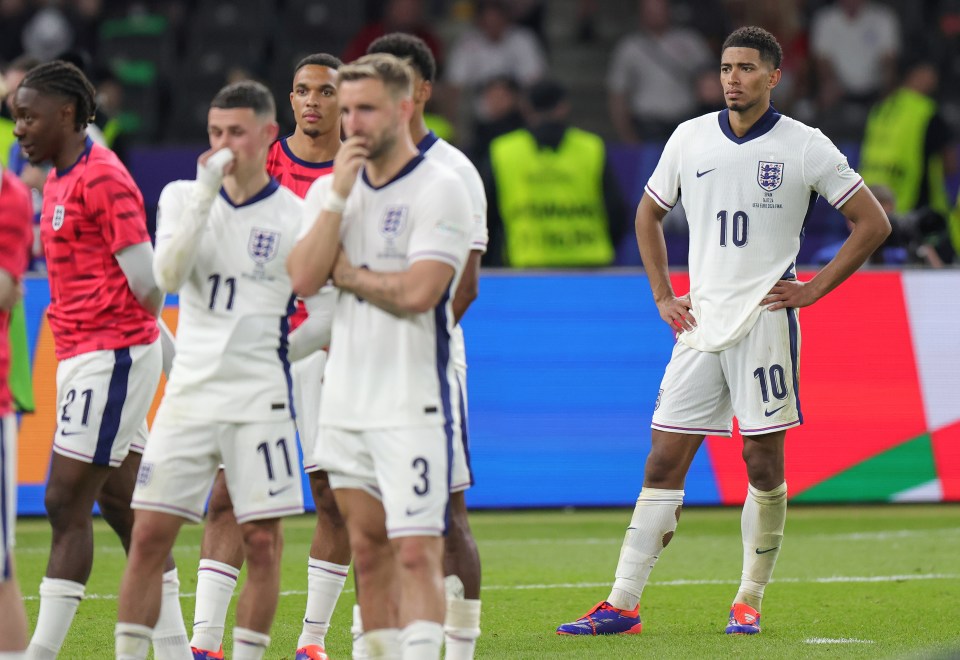 Phil Foden, Luke Shaw and Jude Bellingham looking on as Spain lift the trophy