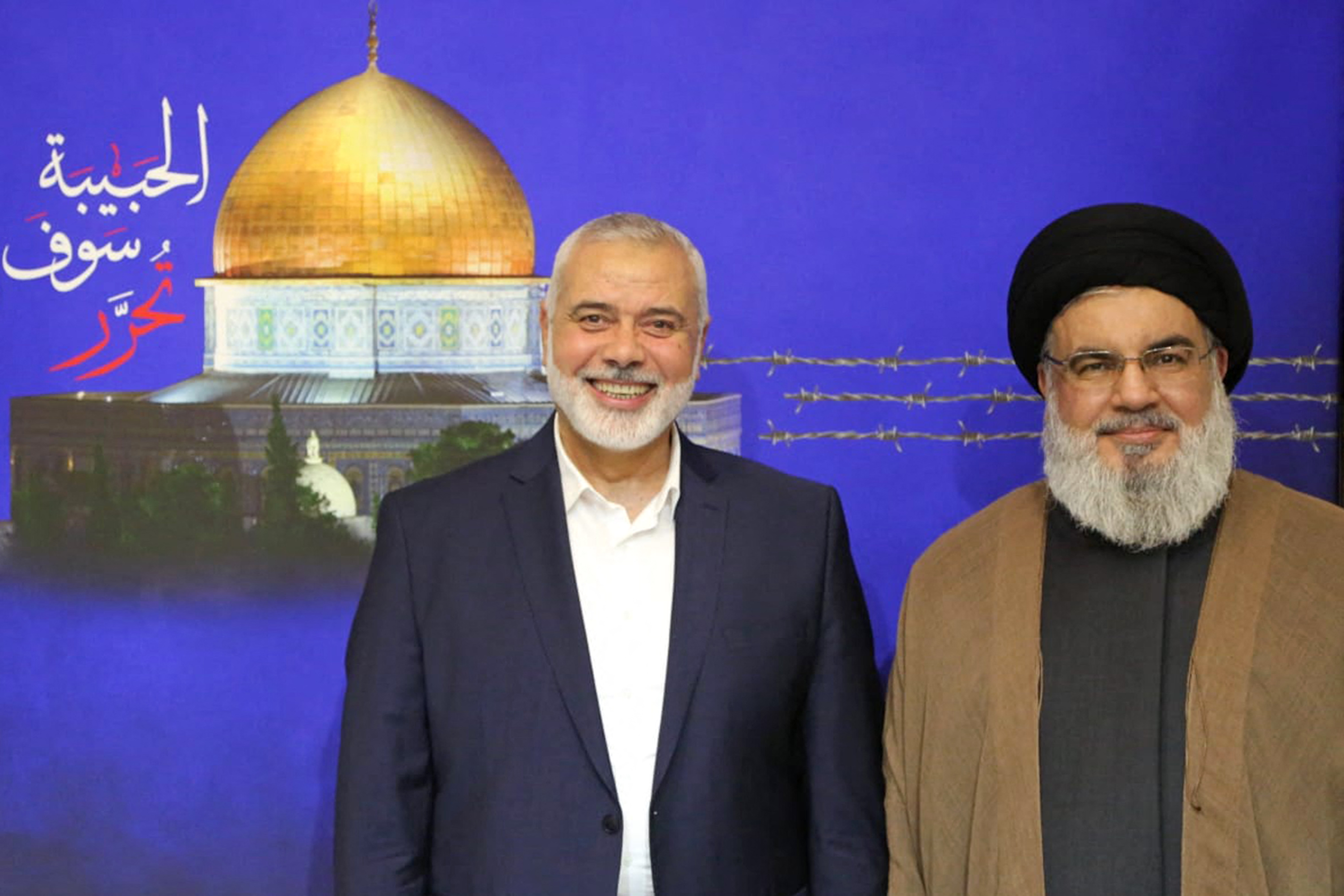 Leader of Hezbollah Hasan Nasrallah (R) posing for a picture with Ismail Haniyeh following their meeting at an undisclosed location in 2022