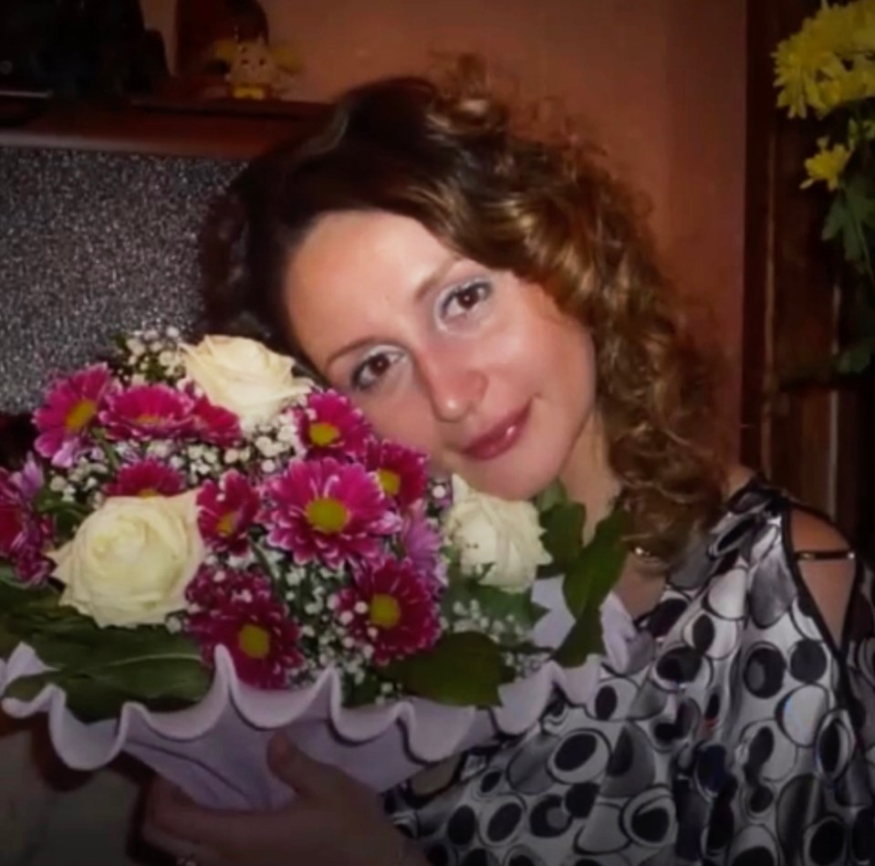 a woman holding a bouquet of pink and white flowers