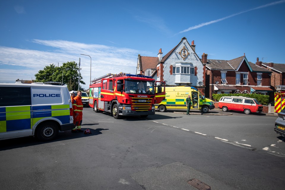 a scania fire truck is parked next to a police van