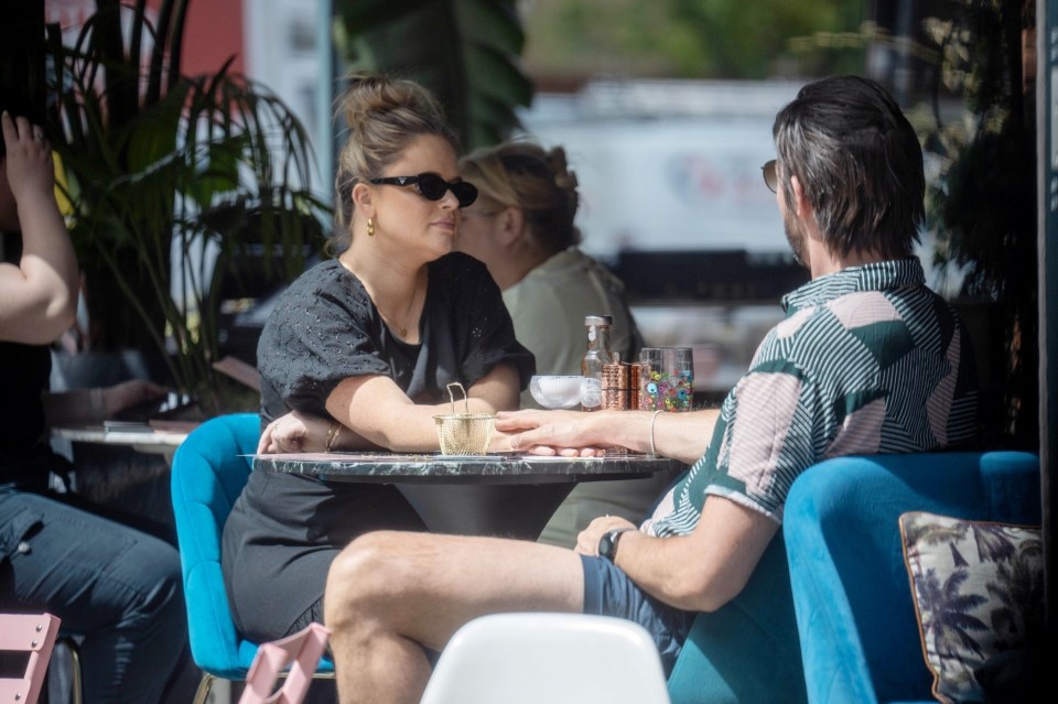 Emily and Alistair held hands over the table