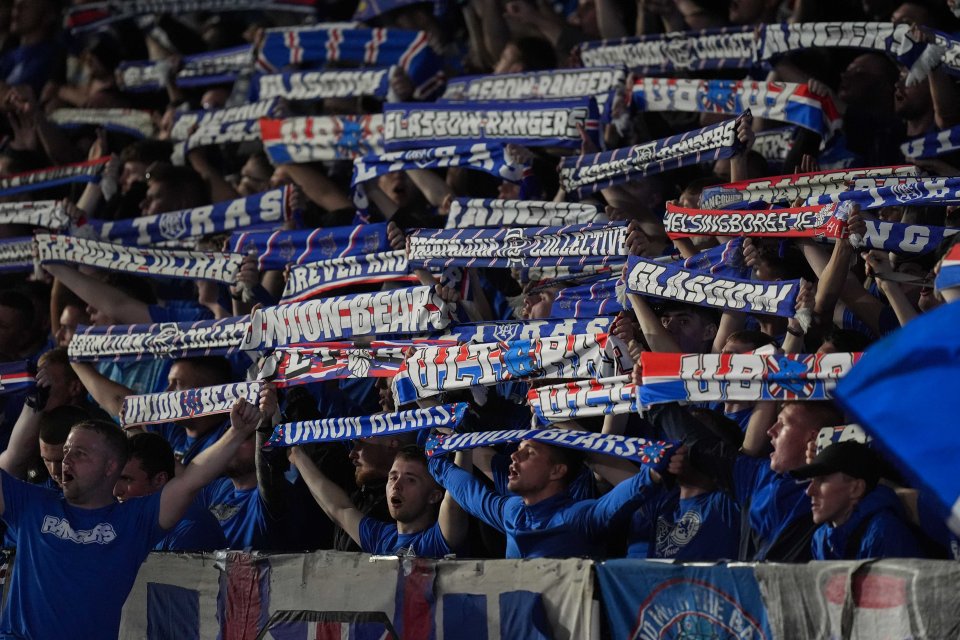 a crowd of people holding up scarves that say glasgow rangers