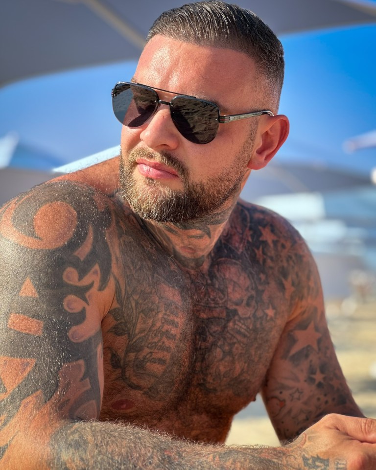 a shirtless man with tattoos on his arms and chest is wearing sunglasses