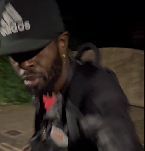 a man wearing a black hat with the word adidas on it