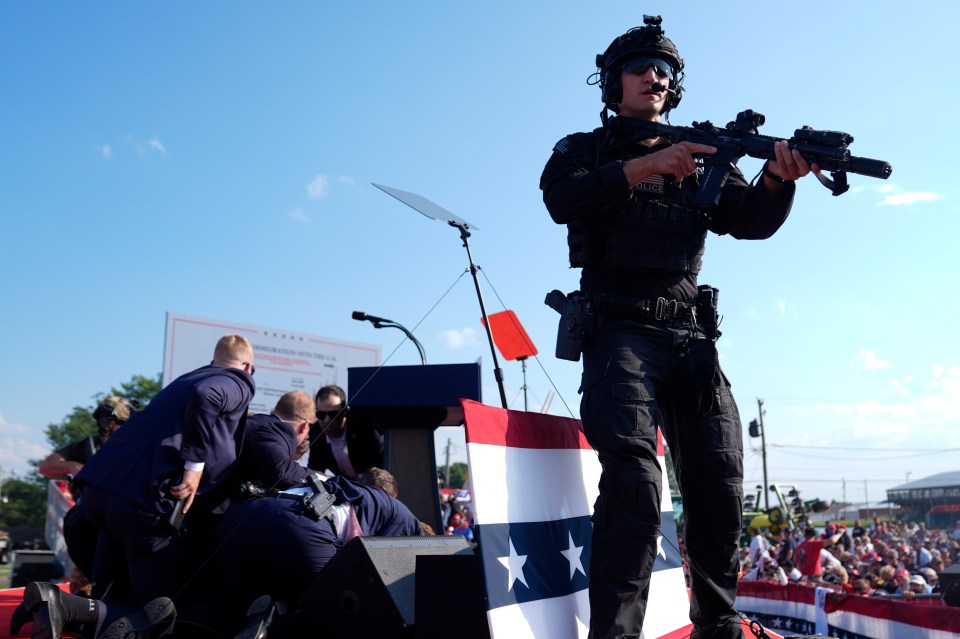 An armed officer jumps to action at the rally